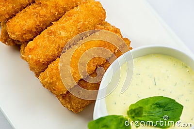 Meat fried in batter with dill in squared plate over white background Stock Photo