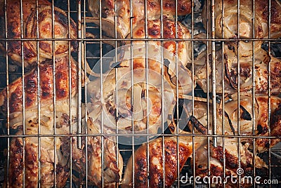 The meat is fried on coals in a metal grill. Preparation of barbecue in nature. Stock Photo