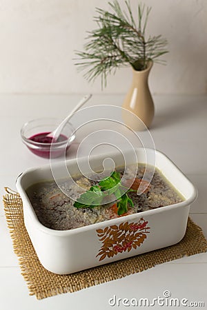 Meat jellied meat with parsley in a traditional dish. Festive dishes. Stock Photo