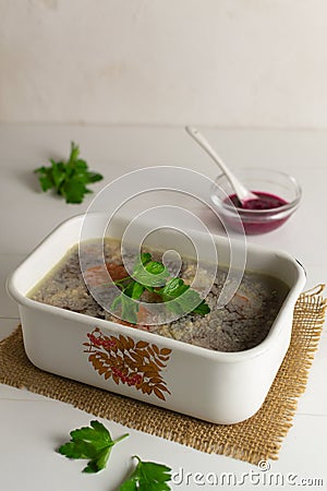 Meat jellied meat with parsley in a traditional dish. Festive dishes. Rustic style. Stock Photo