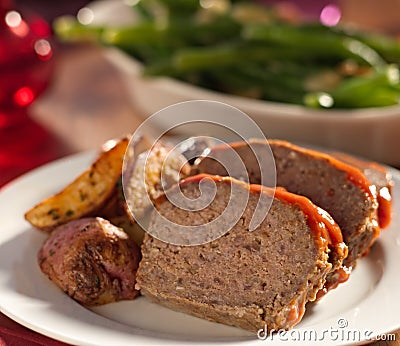 Meat loaf with roasted herb potatoes Stock Photo