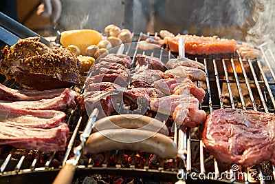 The meat is pickled on a lattice grill, ribs spread, a stake, Sausages, edges, chicken, naked flame, black pepper, a Stock Photo
