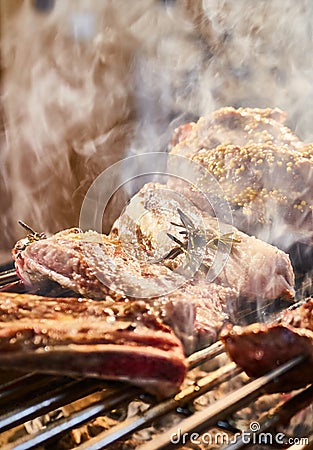 The meat is pickled on a lattice grill, ribs spread, a stake, Sausages, edges, chicken, naked flame, black pepper, a Stock Photo