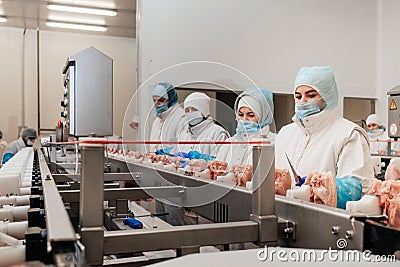 Automated production line with packaging and cutting of meat in modern food factory.Meat processing equipment. Stock Photo