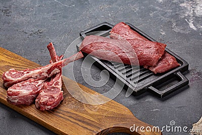 Meat Raw Fresh Mutton on the bone Spices Chesno and Rosemary on a black background Stock Photo