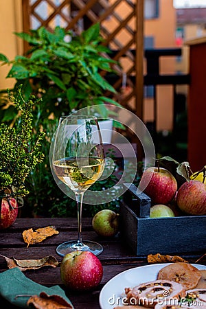 Meat roll filled with pistachios and prunes, white wine glass on rustic wooden table Stock Photo