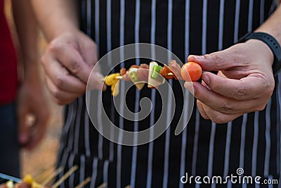 Meat and skewers ingredients for barbecue party are placed on grill to cook barbecue and make it ready for family to join barbecue Stock Photo