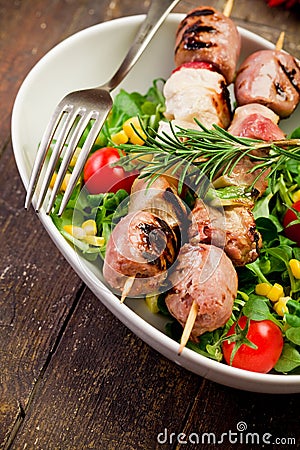 Meat Skewers on wooden table Stock Photo