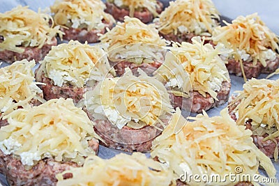 Meat stacks raw fresh pork cutlets with fried onions and boiled eggs and potatoes Stock Photo