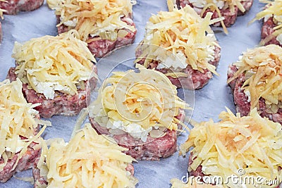 Meat stacks raw fresh pork cutlets with fried onions and boiled eggs and potatoes Stock Photo