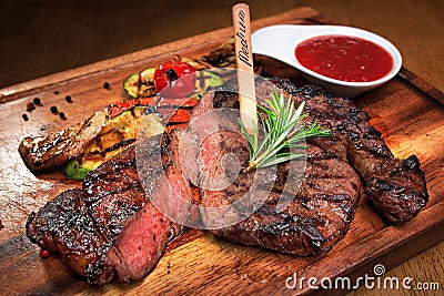 Meat steak on the wooden board Stock Photo