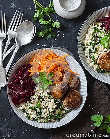 Meatballs, bulgur, carrots, beets bowl on dark background, top view Stock Photo