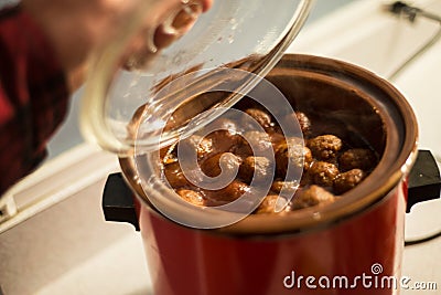 Meatballs in crock pot slow cooker Stock Photo