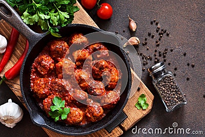 Meatballs in sweet and sour tomato sauce on the kitchen table. Top view Stock Photo