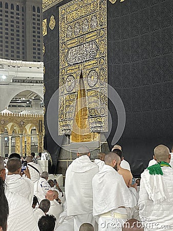 Male worshipers pray at the door of the Kaaba Editorial Stock Photo