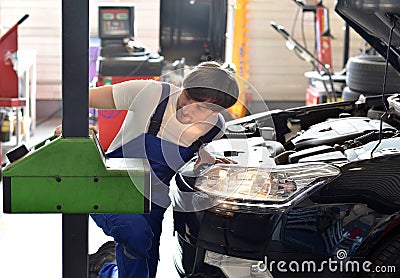 Mechanic adjusts headlights from the car in a workshop Stock Photo