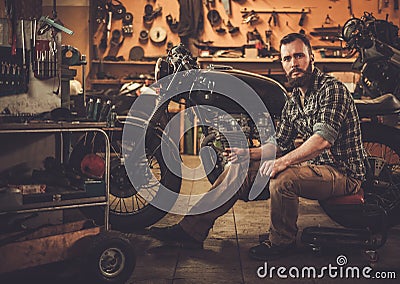 Mechanic building vintage style cafe-racer motorcycle Stock Photo