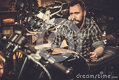 Mechanic building vintage style cafe-racer motorcycle Stock Photo