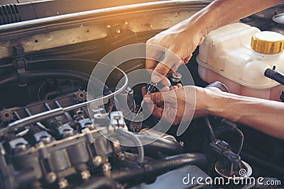 Mechanic Car Service in automobile garage auto car and vehicles service mechanical engineering. Automobile mechanic hands car Stock Photo