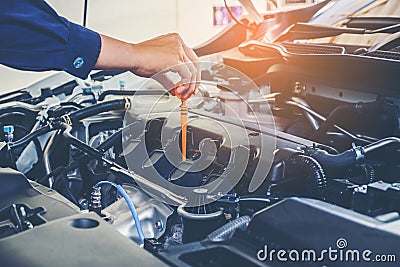 Mechanic changing oil mechanic in auto repair service. Stock Photo