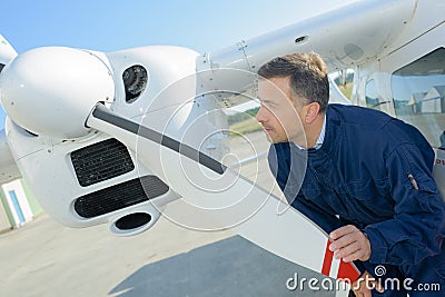 Mechanic checking propellor on aircraft Stock Photo