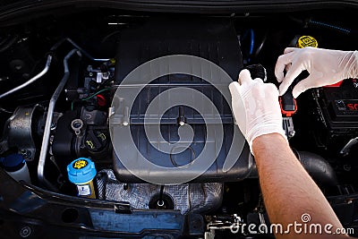 Mechanic checks auto electronic control unit Stock Photo