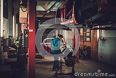 Mechanic in classic car restoration workshop Stock Photo