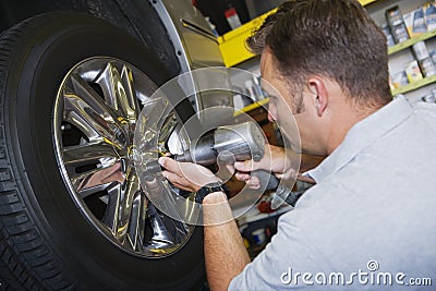 Mechanic Fixing Bolts With Electronic Fitter Stock Photo