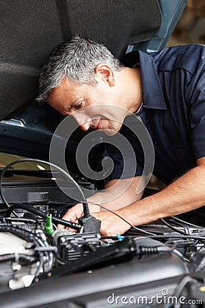 Mechanic fixing car Stock Photo