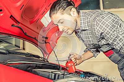 Mechanic fixing and checking a car Stock Photo