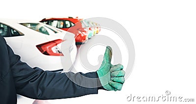 The mechanic gets a thumbs up and vehicle group backdrop Stock Photo