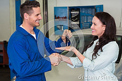 Mechanic giving keys to satisfied customer Stock Photo