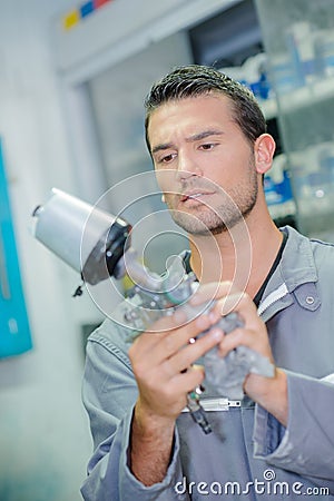 Mechanic holding spare part Stock Photo