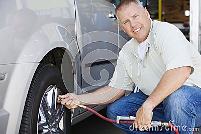 Mechanic Inflating RV~s Tire Stock Photo