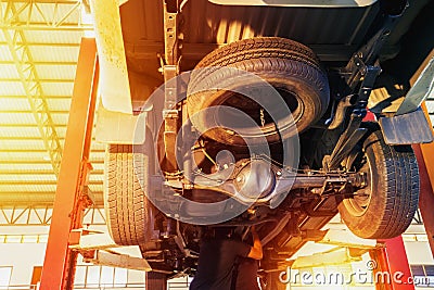 Mechanic inspect car suspension system and chassis under the car Stock Photo