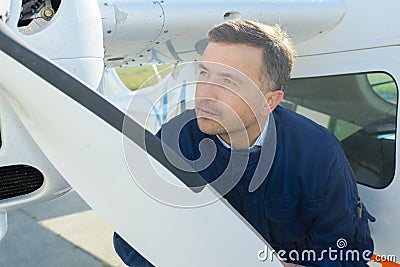 Mechanic looking at aircraft propellor Stock Photo