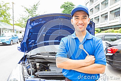 Mechanic man with tool for repair car. Auto repair service Stock Photo