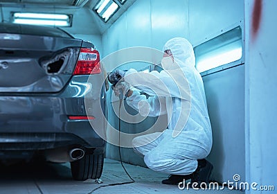 Mechanic man works with grinding tool. Sanding of car elements. Garage painting car service repair and maintenance Stock Photo