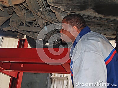 Mechanic Performing a Routine Service Inspection Stock Photo