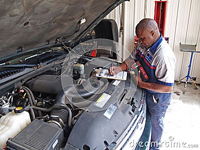 Mechanic Performing a Routine Service Inspection Stock Photo