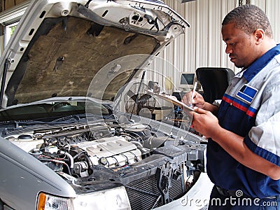Mechanic Performing a Routine Service Inspection Stock Photo