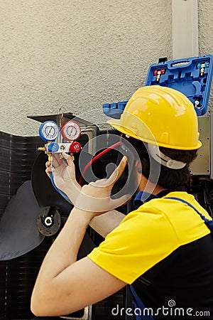 Mechanic on the phone with home owner Stock Photo