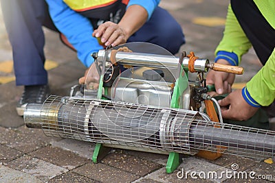 The mechanic is repairing the machine - spraying mosquitoes Stock Photo