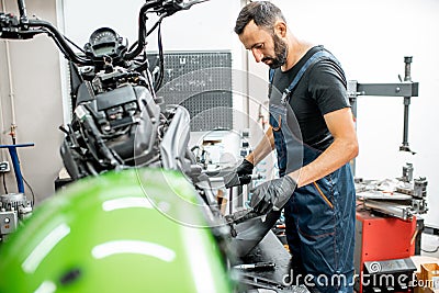 Mechanic repairing a motorcycle Stock Photo