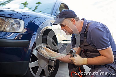 Mechanic repairman making tyre in workshop Stock Photo