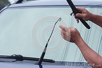 Mechanic replace windshield wipers on car. Replacing wiper blades Stock Photo