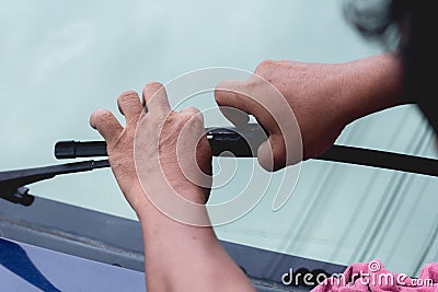 Mechanic replace windshield wipers on car. Replacing wiper blades Stock Photo