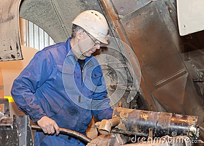 Mechanic serves mechanisms Stock Photo