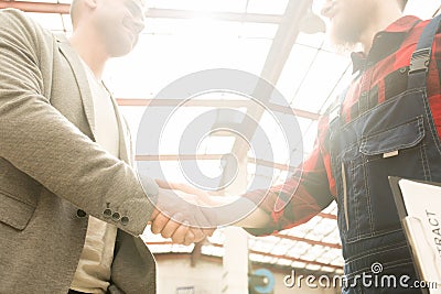 Mechanic Shaking Hands With Customer Stock Photo