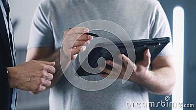Mechanic with a tablet consulting a client Stock Photo